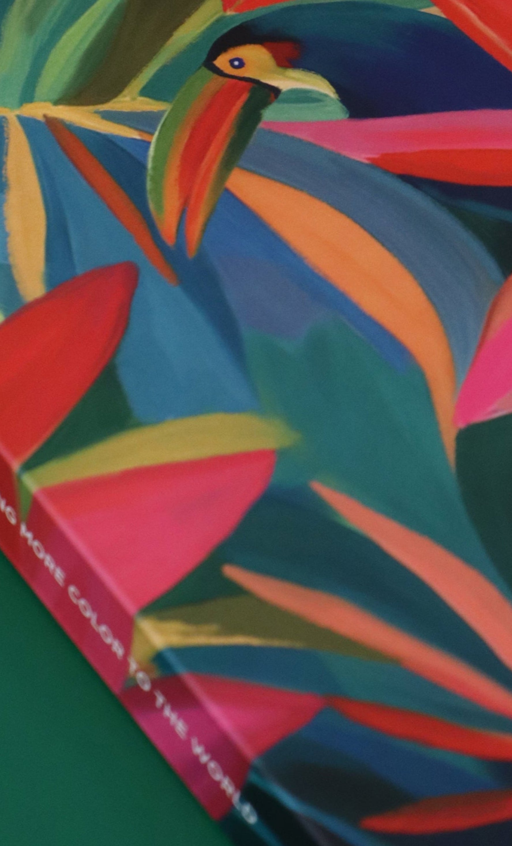 Colorful book cover with bird and leaf design on a green background